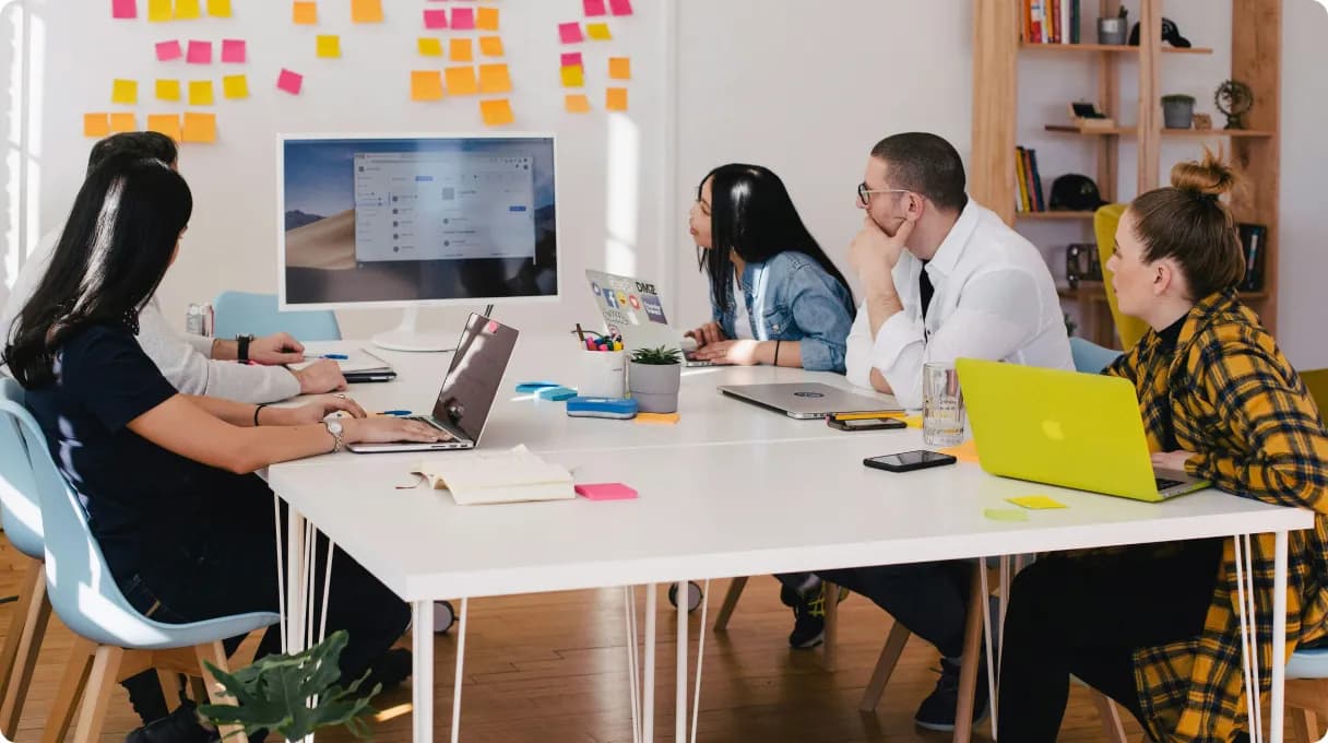 three-men-sitting-on-chair-beside-tables