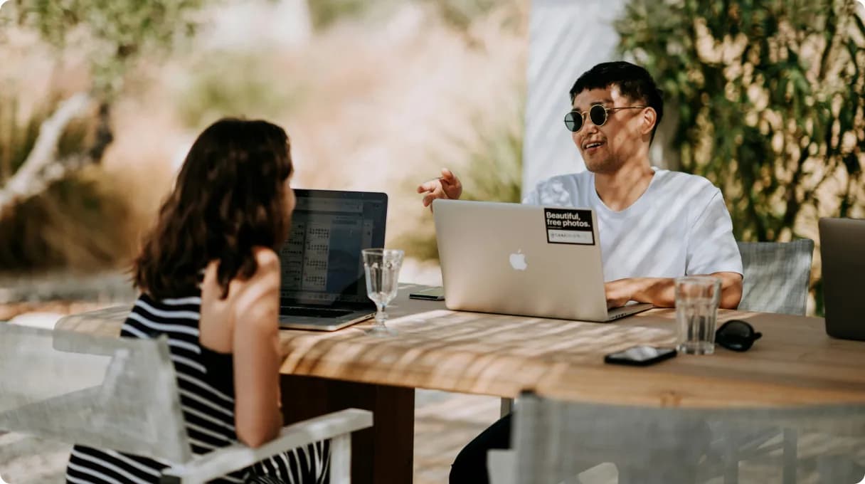 three-men-sitting-on-chair-beside-tables